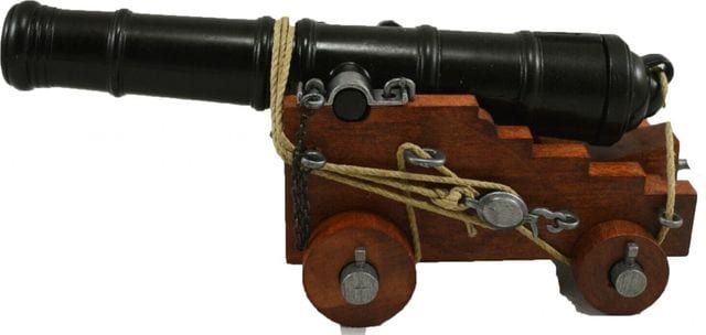 A black naval cannon on a wooden carriage, lashed down with rope.